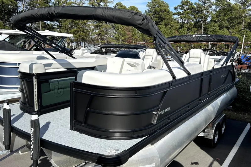 Slide: The Image of 2026 Godfrey SWEETWATER 2486 DT pontoon boat with sleek black design and spacious seating. - 0