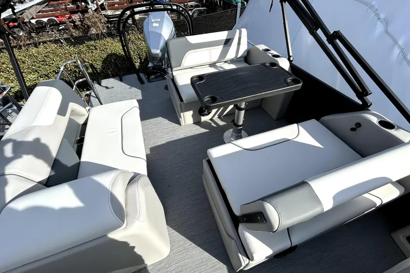 Slide: The Image of 2026 Godfrey SWEETWATER 2486 DT boat interior with seating and table. - 10