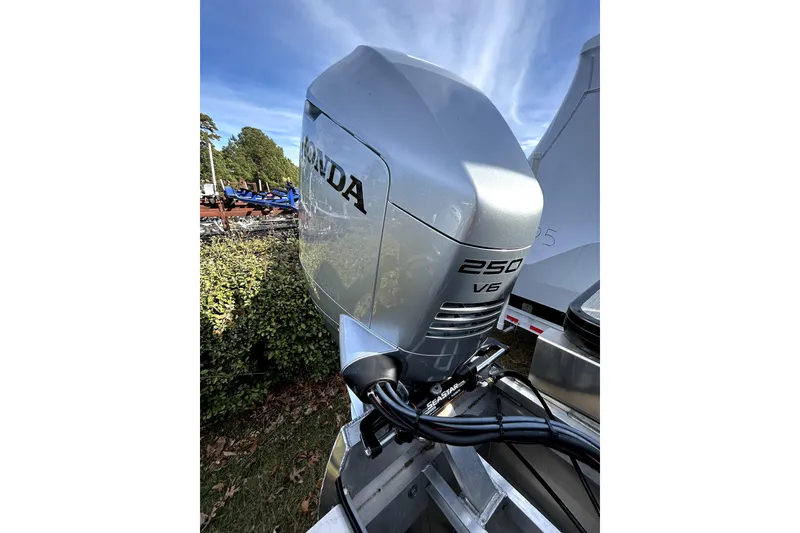 Slide: The Image of Silver Honda 250 V6 outboard motor on a 2026 Godfrey SWEETWATER 2486 DT boat. - 3