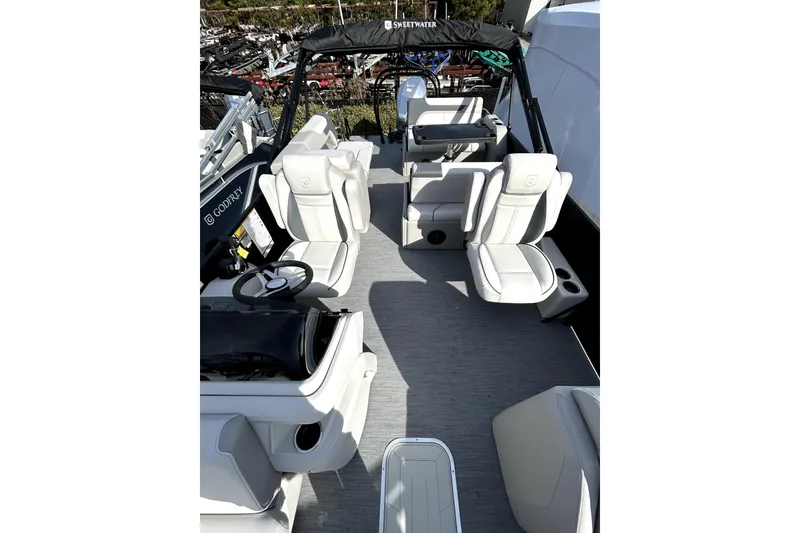 Slide: The Image of 2026 Godfrey SWEETWATER 2486 DT pontoon boat interior with white seating and steering console. - 8