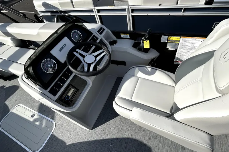 Slide: The Image of 2026 Godfrey SWEETWATER 2486 DT boat interior with steering wheel and control panel. - 9