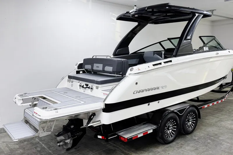 Slide: The Image of 2026 Chaparral SSX 30 boat on trailer, rear view in showroom. - 1