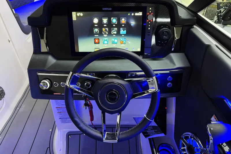 Slide: The Image of 2026 Chaparral SSX 30 boat dashboard with touchscreen and steering wheel. - 14