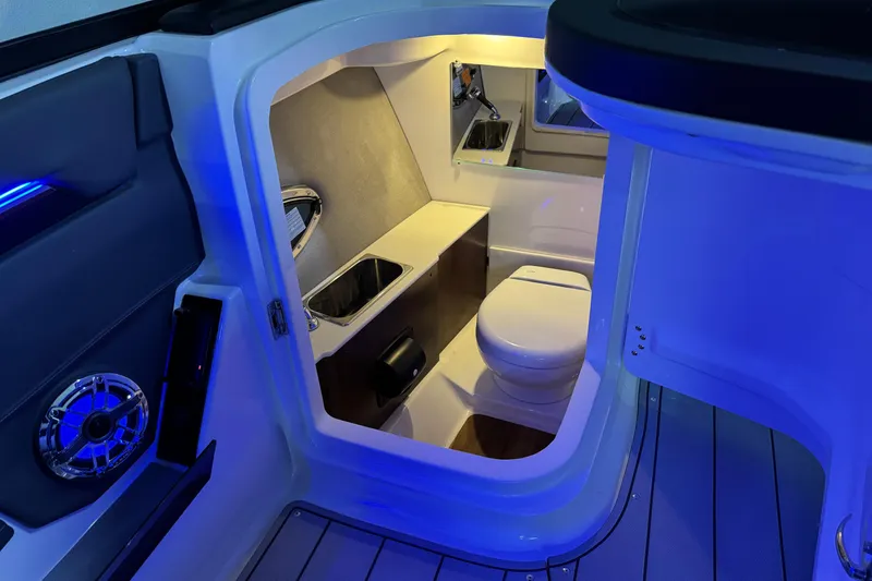 Slide: The Image of 2026 Chaparral SSX 30 boat interior with modern bathroom and blue ambient lighting. - 25