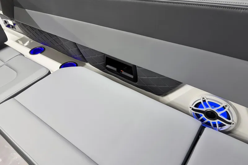 Slide: The Image of 2026 Chaparral SSX 30 boat interior with blue LED-lit speakers and cushioned seating. - 29