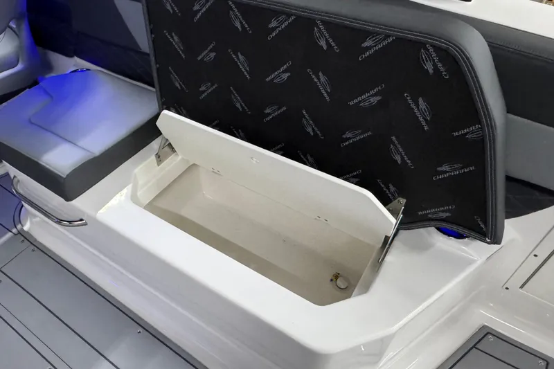 Slide: The Image of 2026 Chaparral SSX 30 boat storage compartment with open lid, showcasing interior space. - 32