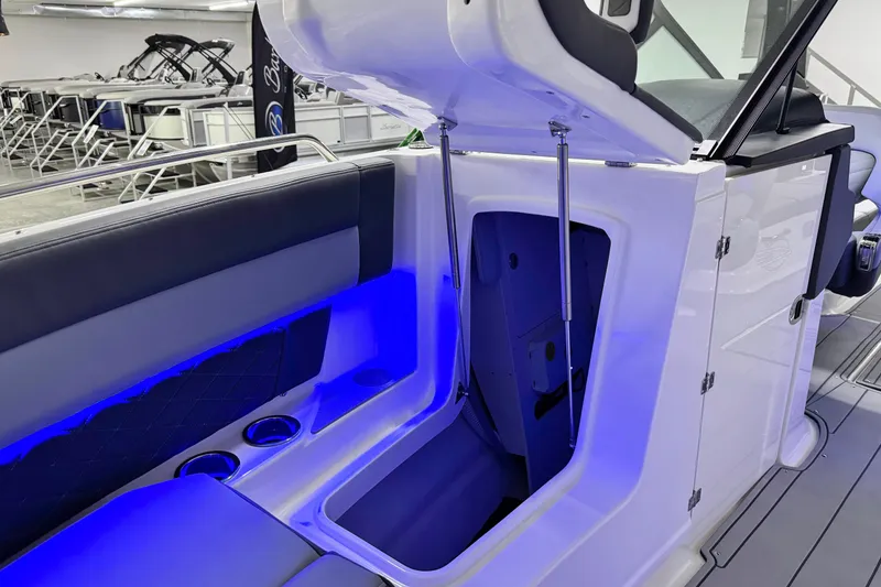 Slide: The Image of 2026 Chaparral SSX 30 boat interior with blue LED lighting and storage compartment. - 38