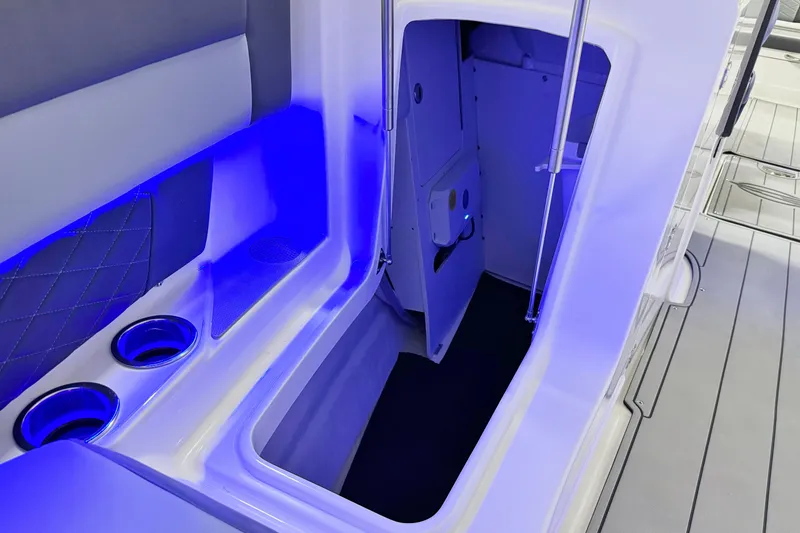 Slide: The Image of 2026 Chaparral SSX 30 boat interior with blue LED lighting and cup holders. - 39