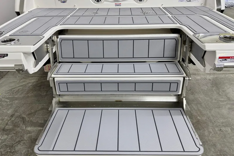 Slide: The Image of 2026 Chaparral SSX 30 boat swim platform with integrated steps and cup holders. - 4