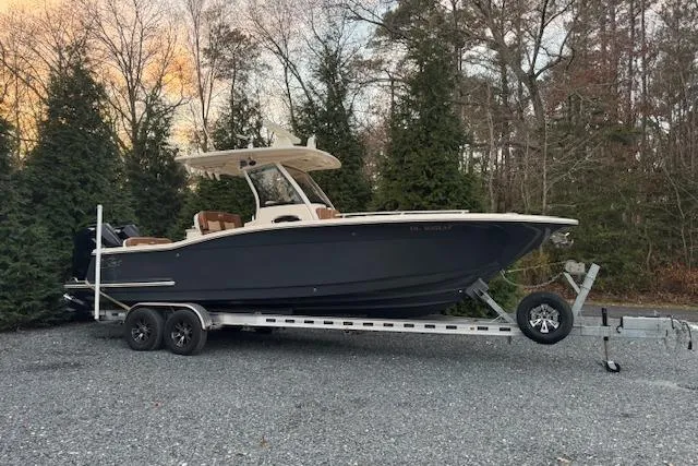 The Image of 2023 Scout 277 LXF boat on trailer under clear blue sky. - 0