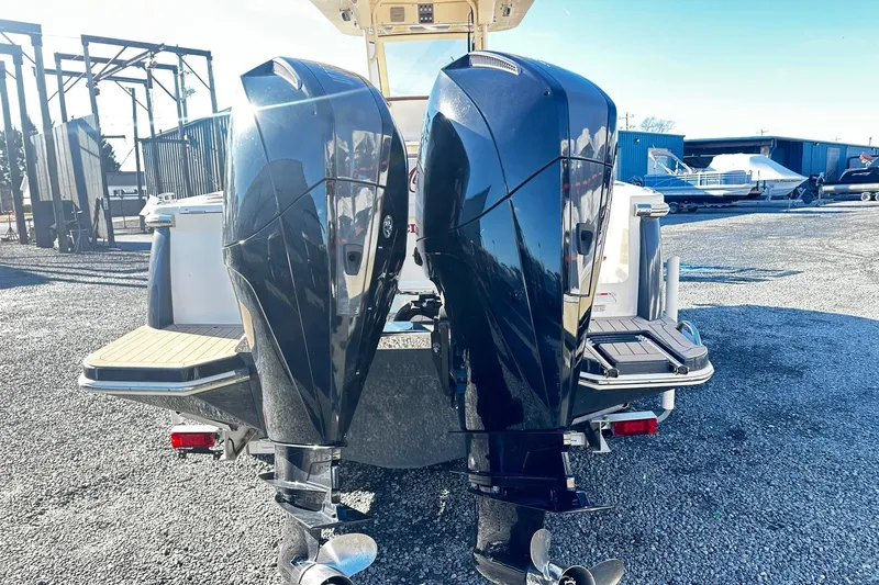 Slide: The Image of 2023 Scout 277 LXF boat with dual outboard motors in a marina setting. - 11