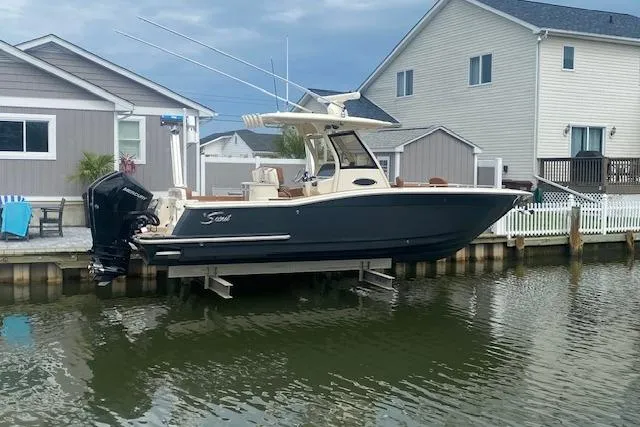Slide: The Image of 2023 Scout 277 LXF boat on display, featuring sleek design and modern amenities. - 2