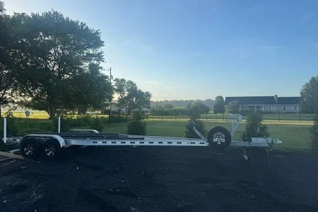 Slide: The Image of 2023 Scout 277 LXF boat docked by the waterfront on a cloudy day. - 5