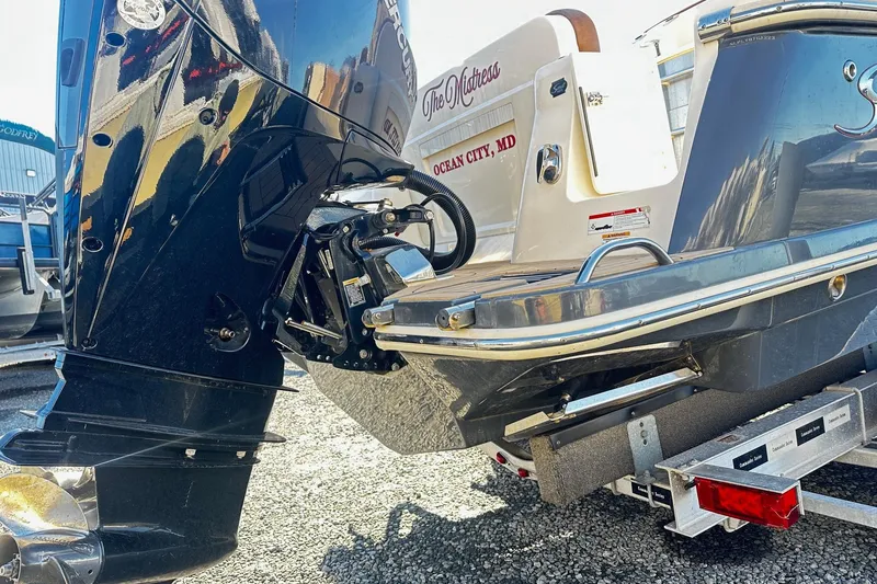 Slide: The Image of 2023 Scout 277 LXF boat rear view with motor and trailer. - 7