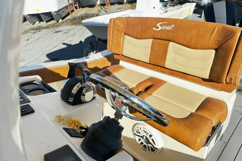 Slide: The Image of 2023 Scout 277 LXF boat interior with leather seating and steering wheel. - 9
