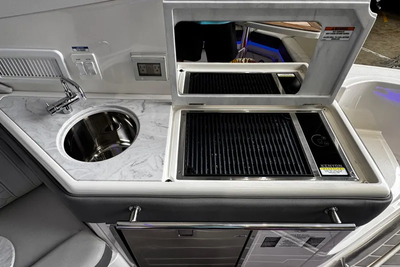 Slide: The Image of 2022 Sea Ray Sundancer 320 Outboard kitchenette with sink and grill. - 10