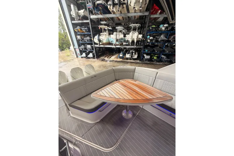Slide: The Image of 2022 Sea Ray Sundancer 320 Outboard interior with elegant seating and wooden table. - 11