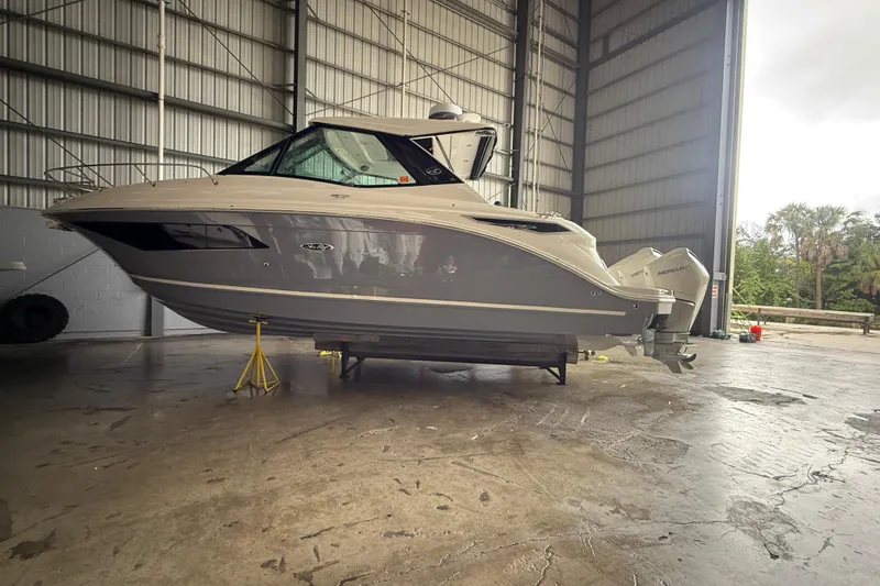 Slide: The Image of 2022 Sea Ray Sundancer 320 Outboard in a spacious indoor storage facility. - 12