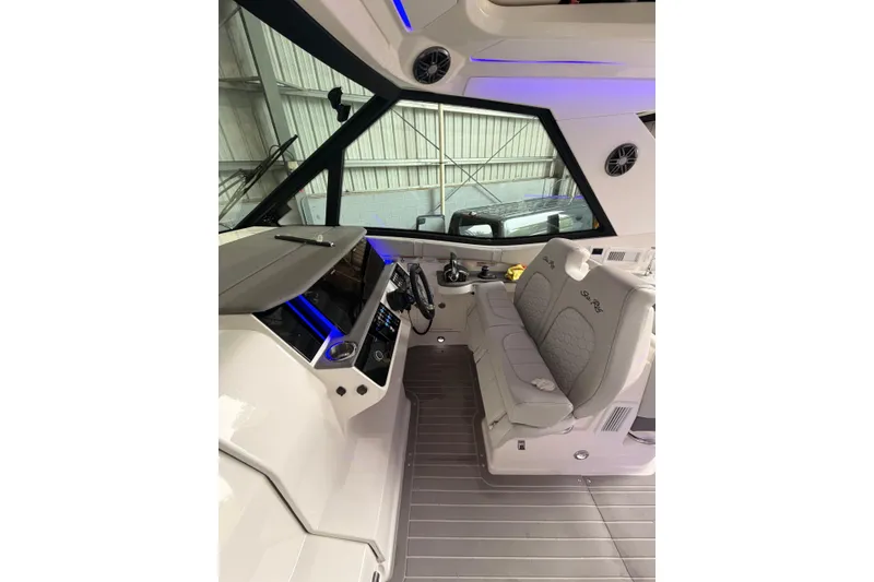 Slide: The Image of 2022 Sea Ray Sundancer 320 Outboard cockpit with modern seating and controls. - 13