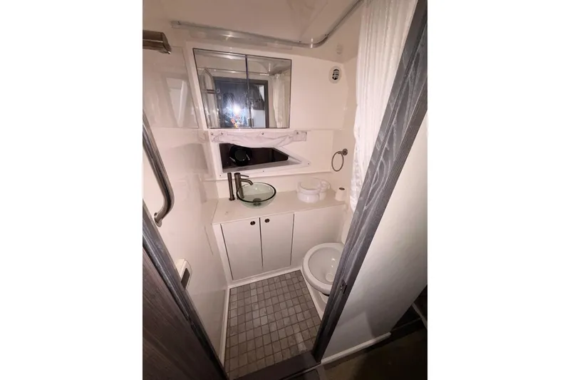 Slide: The Image of 2022 Sea Ray Sundancer 320 Outboard bathroom with modern fixtures and compact design. - 15