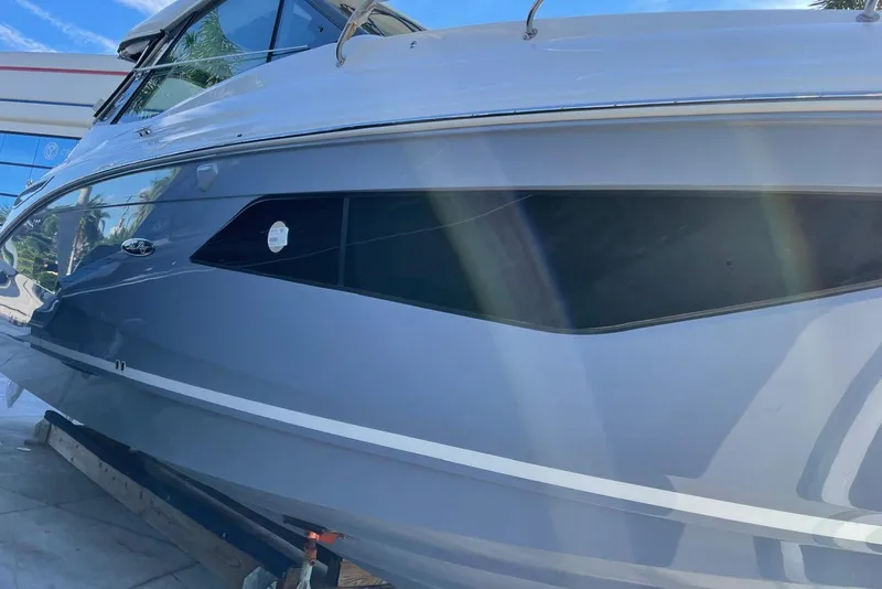 Slide: The Image of 2022 Sea Ray Sundancer 320 Outboard boat side view with sleek design. - 2