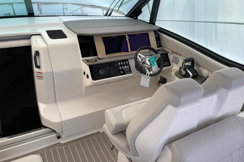 Slide: The Image of 2022 Sea Ray Sundancer 320 Outboard helm with dual screens and modern controls. - 3