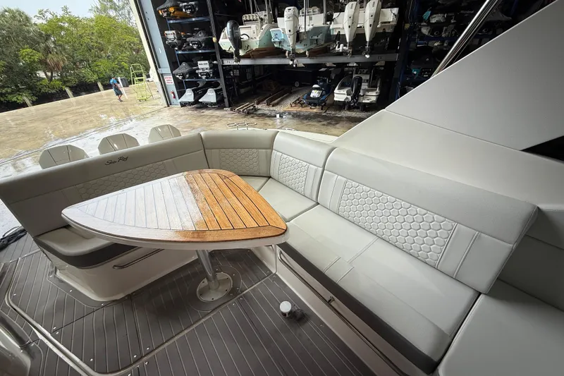 Slide: The Image of 2022 Sea Ray Sundancer 320 Outboard interior with elegant seating and wooden table. - 4