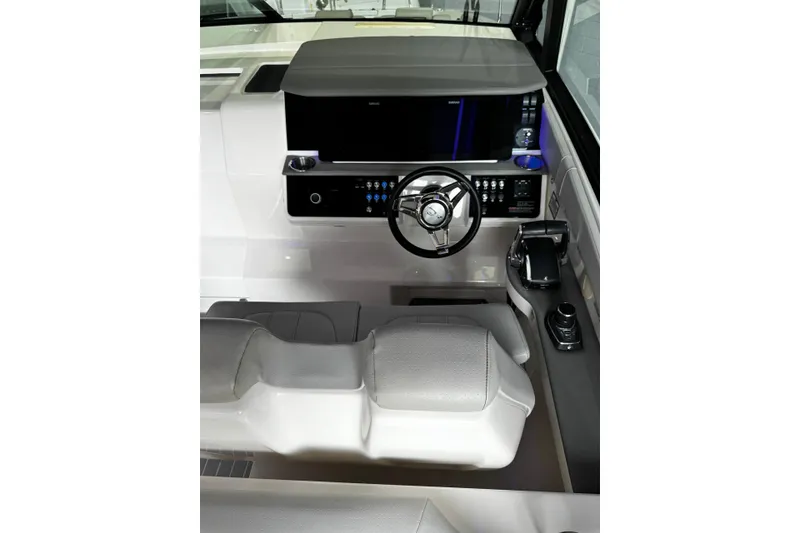 Slide: The Image of 2022 Sea Ray Sundancer 320 Outboard helm with modern controls and steering wheel. - 9
