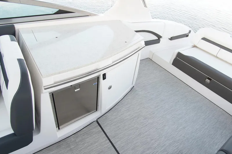Slide: The Image of 2026 Regal 3300 boat interior with luxurious seating at a boat show. - 10