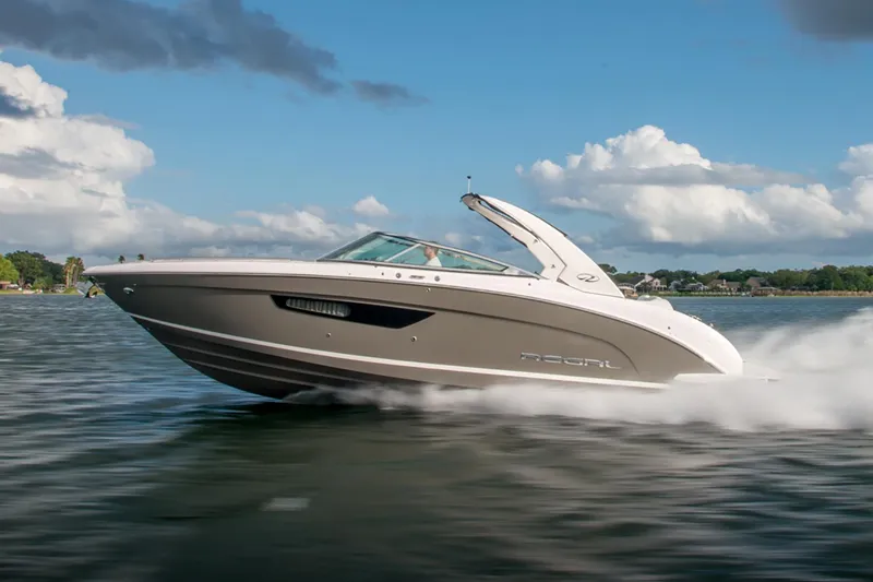 Slide: The Image of 2026 Regal 3300 boat displayed at an indoor exhibition with seating area. - 2
