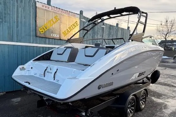 Slide: The Image of 2026 Yamaha Boats AR250 on trailer, sleek design, parked outdoors. - 2