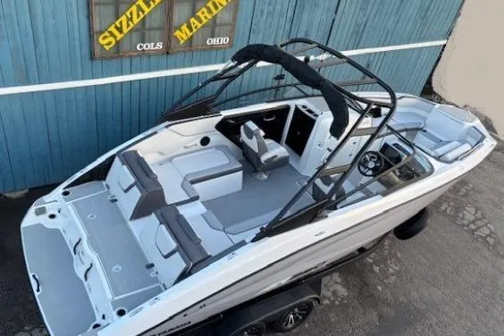 Slide: The Image of 2026 Yamaha Boats AR250 with sleek design and spacious seating, displayed outdoors. - 5