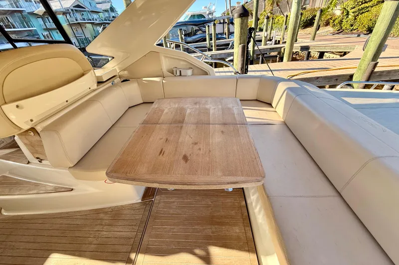 Slide: The Image of 2016 Cranchi M44 HT yacht docked, featuring spacious seating and modern navigation equipment. - 14