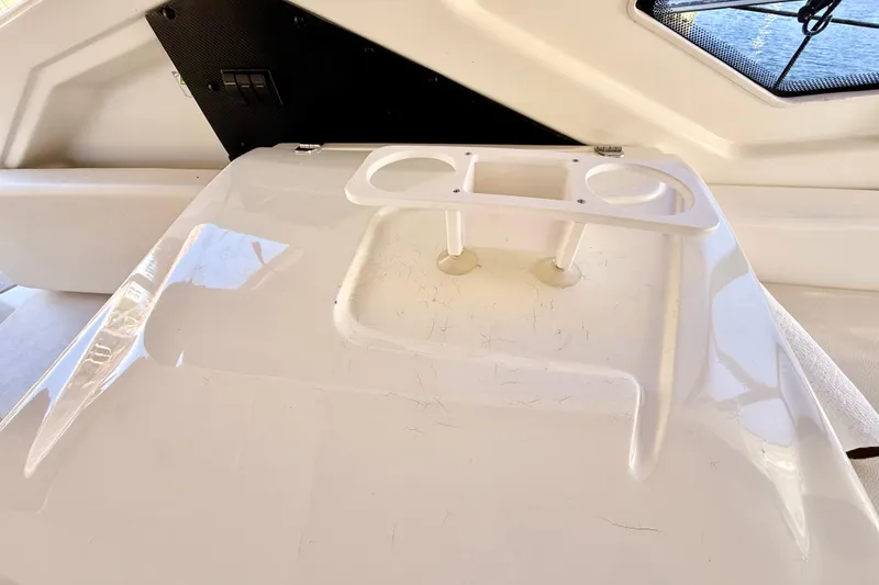 Slide: The Image of 2016 Cranchi M44 HT yacht interior with beige seating and wooden dock view. - 143