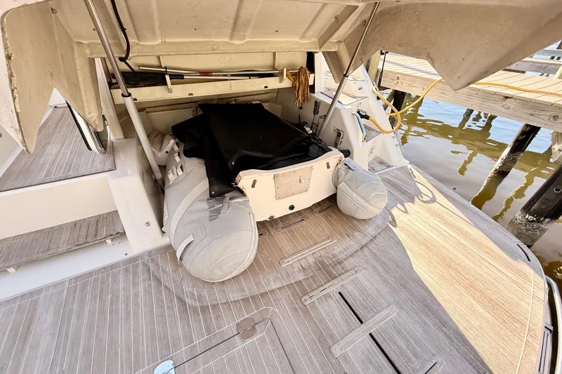 Slide: The Image of 2016 Cranchi M44 HT yacht docked, reflecting sunlight on water. - 145