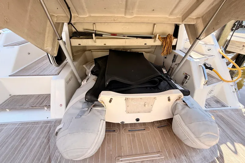 Slide: The Image of 2016 Cranchi M44 HT yacht docked, reflecting sunlight on water. - 146