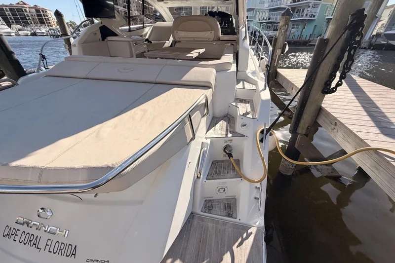 Slide: The Image of 2016 Cranchi M44 HT yacht docked, showcasing sleek design and spacious deck. - 150