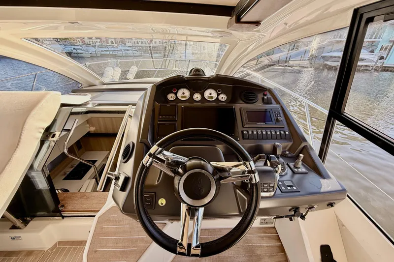 Slide: The Image of Control panel of a 2016 Cranchi M44 HT yacht with navigation and throttle controls. - 34