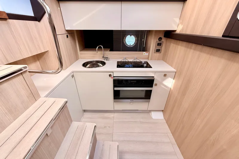 Slide: The Image of Interior of 2016 Cranchi M44 HT yacht featuring compact kitchen and wooden stairs. - 47