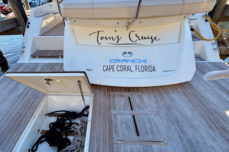 Slide: The Image of 2016 Cranchi M44 HT yacht docked at marina with open storage compartment. - 5