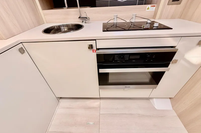 Slide: The Image of Modern kitchen area in 2016 Cranchi M44 HT yacht with sleek design and round sink. - 54