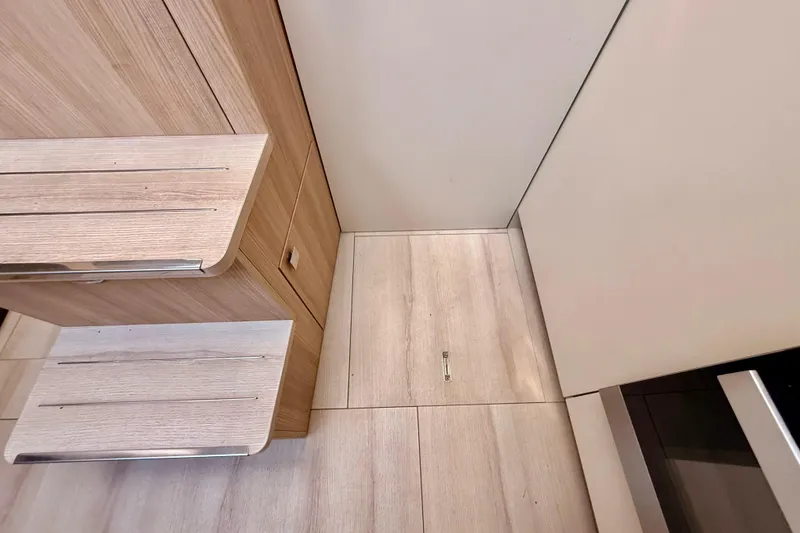 Slide: The Image of 2016 Cranchi M44 HT yacht kitchen with sink, stove, and storage cabinets. - 56