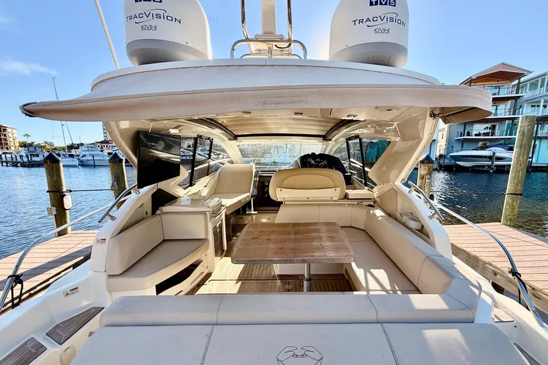 Slide: The Image of Luxurious 2016 Cranchi M44 HT yacht interior with elegant seating and wooden table. - 8