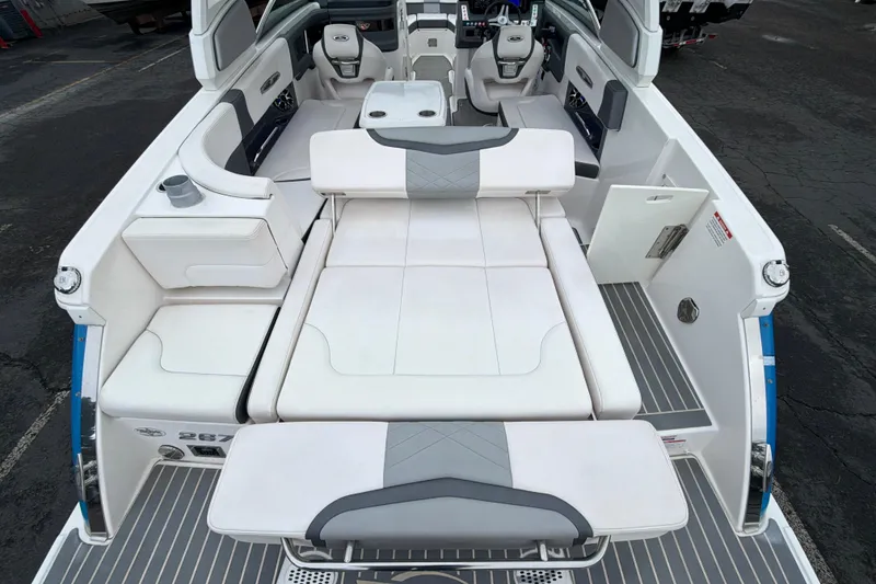 Slide: The Image of 2018 Chaparral 267 SSX boat interior with white seating and modern design. - 12