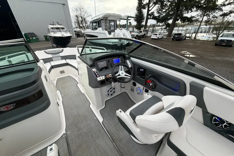 Slide: The Image of 2018 Chaparral 267 SSX boat interior with modern dashboard and seating. - 16