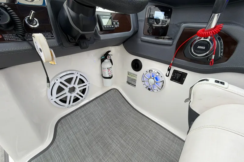 Slide: The Image of 2018 Chaparral 267 SSX boat dashboard with speakers, fire extinguisher, and control panel. - 21