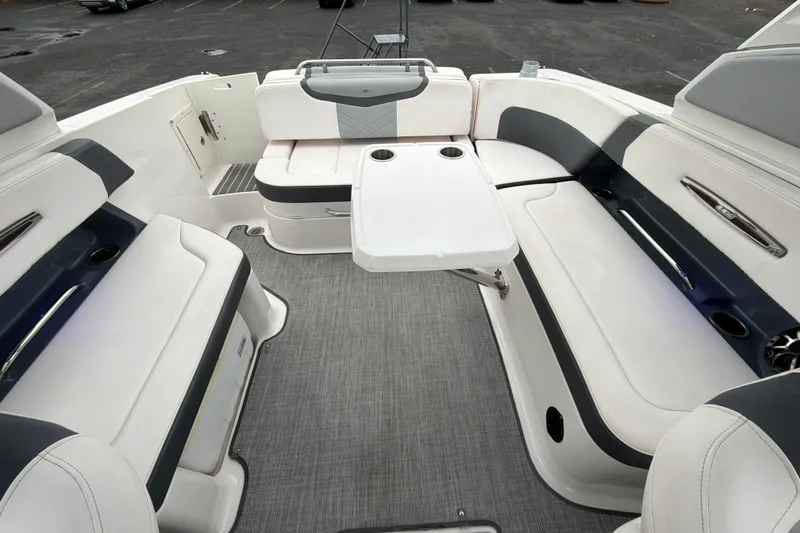 Slide: The Image of 2018 Chaparral 267 SSX boat interior with white seating and table. - 31