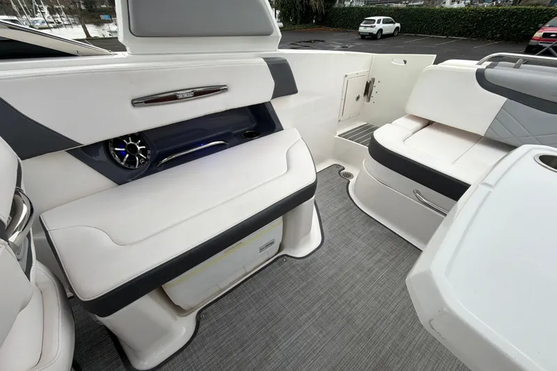 Slide: The Image of 2018 Chaparral 267 SSX boat interior with white seating and modern design. - 32