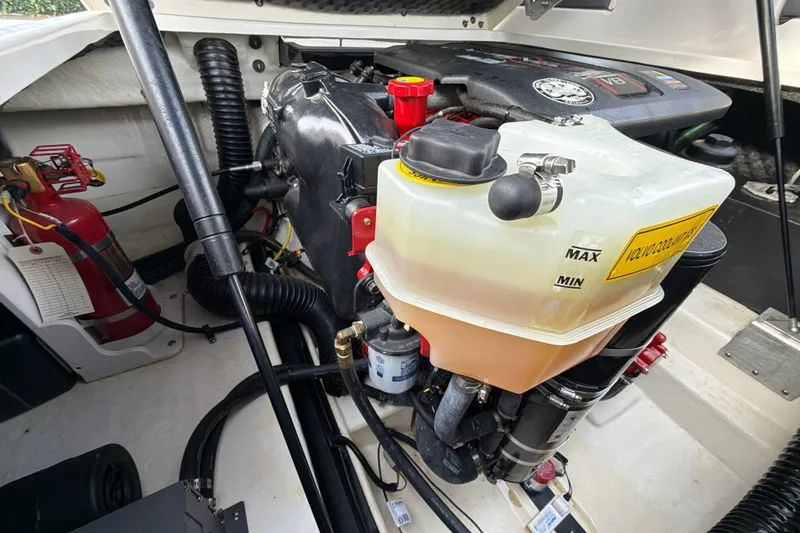 Slide: The Image of Engine compartment of 2018 Chaparral 267 SSX boat with visible coolant reservoir and fire extinguisher. - 36