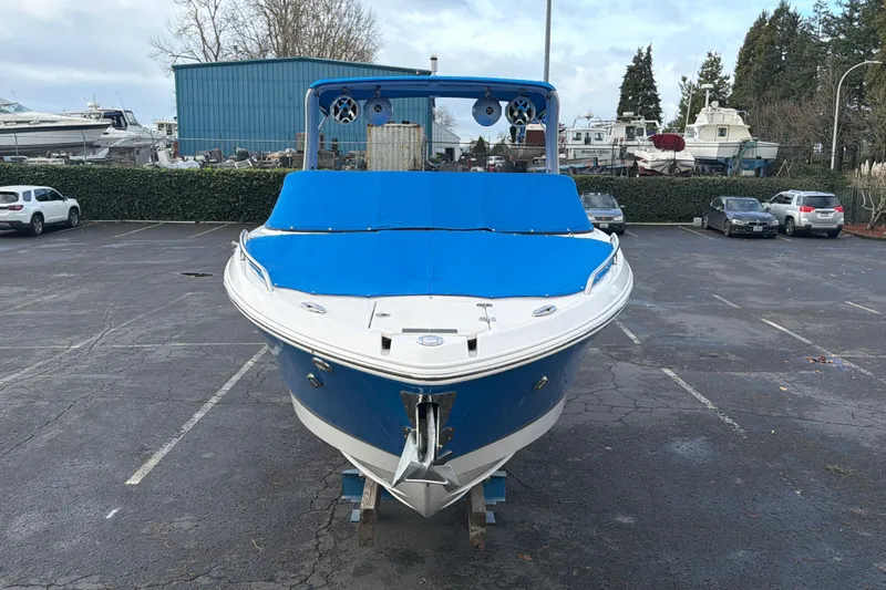 Slide: The Image of 2018 Chaparral 267 SSX boat with blue cover in a parking lot. - 38